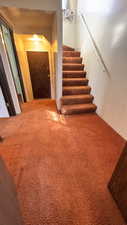 Stairway featuring carpet flooring