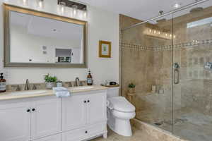 Bathroom featuring double vanity and a shower stall