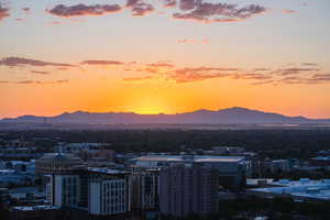 View of mountain backdrop featuring nearby urban area