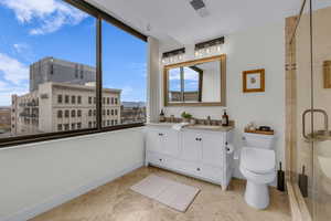 Full bathroom featuring double vanity, a mountain view, a stall shower, and light tile patterned floors