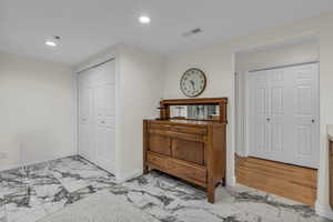 Kitchen with recessed lighting and light marble finish flooring