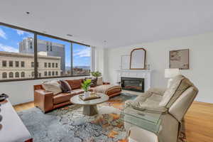 Living area featuring wood finished floors and a glass covered fireplace