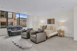 Living area with carpet flooring and recessed lighting