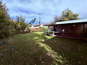 View of green lawn with a patio area
