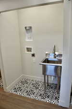 Washroom featuring hookup for a washing machine and wood finished floors