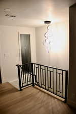 Stairs featuring wood finished floors and baseboards