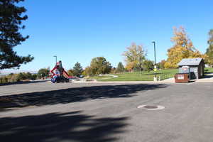 View of asphalt street featuring street lights