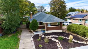 View of front of property featuring roof with shingles and a chimney