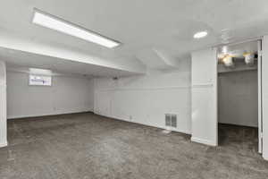 Basement featuring carpet and baseboards