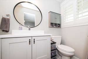 Half bath featuring vanity and toilet