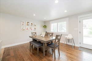 Dining area with light wood-type flooring and recessed lighting