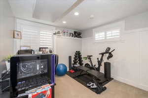 Workout room with recessed lighting, a decorative wall, and carpet flooring