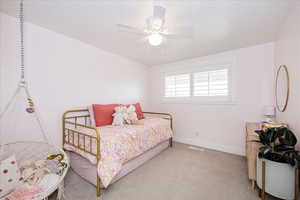 Carpeted bedroom with baseboards and a ceiling fan