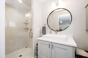 Full bath featuring vanity and a stall shower