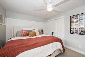 Bedroom featuring carpet flooring, a ceiling fan, and a closet
