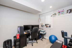 Office area featuring light colored carpet and recessed lighting
