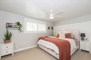 Bedroom with carpet floors and a ceiling fan