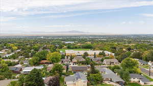 Aerial view of residential area with mountains and a tree filled landscape