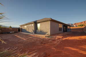 View of side of property featuring a fenced backyard and a mountain view