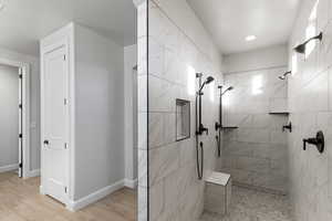 Bathroom featuring walk in shower and light wood finished floors