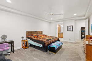 Bedroom with recessed lighting, light carpet, a ceiling fan, and ensuite bath