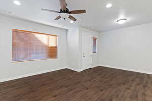 Spare room featuring dark wood-type flooring, a ceiling fan, recessed lighting, and a textured ceiling