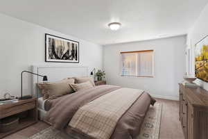 Bedroom with carpet and a textured ceiling