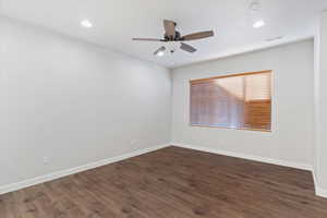 Empty room with dark wood-style floors, recessed lighting, ceiling fan, and a smoke detector