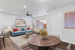 Living area with wood finished floors, recessed lighting, and a ceiling fan