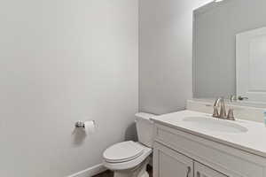 Half bath with vanity and toilet