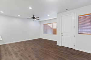 Empty room with recessed lighting, dark wood-type flooring, and a ceiling fan