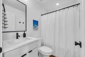 Full bath with vanity and curtained shower
