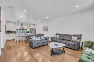 Living room featuring recessed lighting and light wood-style flooring