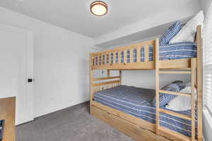 Bedroom with carpet floors and baseboards