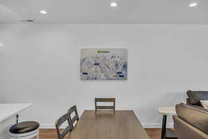 Dining room with recessed lighting and dark wood-style floors