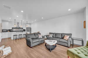 Living room featuring recessed lighting and light wood-type flooring