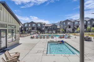 Community pool featuring a patio and a residential view