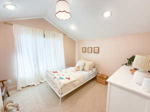 Bedroom featuring light colored carpet, vaulted ceiling, and recessed lighting