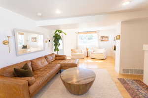 Living room with wood finished floors and recessed lighting