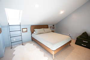 Bedroom with light carpet, vaulted ceiling, and recessed lighting