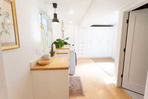 Hall featuring light wood-type flooring and recessed lighting