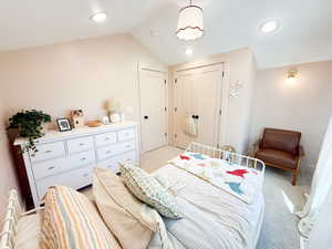 Bedroom featuring lofted ceiling, light colored carpet, a closet, and recessed lighting