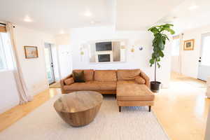 Living room featuring wood finished floors and recessed lighting