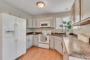 Gray kitchen cabinetry w/gold hardware