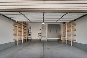 Finished garage w/custom cabinetry and shelving