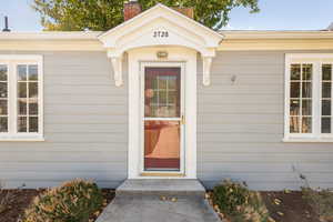 Property entrance with a chimney