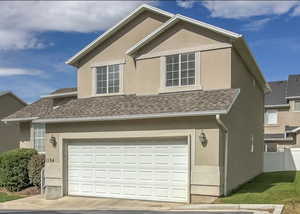 View of property exterior with stucco siding, an attached garage, and a shingled roof