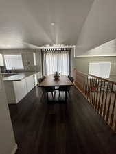 Dining area featuring a textured ceiling and dark wood finished floors