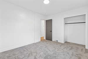 Unfurnished bedroom with carpet floors and a closet