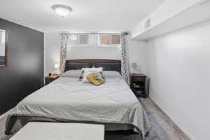 Carpeted bedroom with baseboards